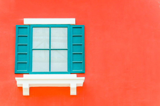 Beautiful window on color wall